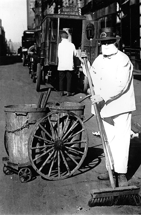 A New York City street sweeper wears a mask while on the job, October 1918.