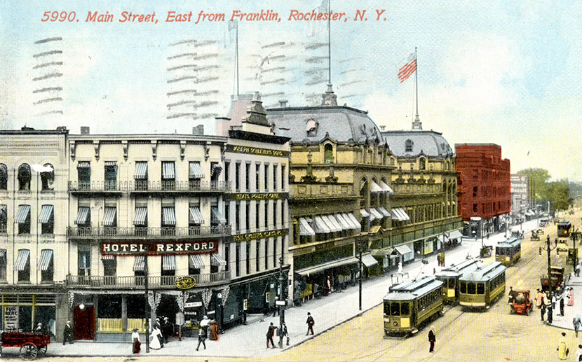 Main Street looking East from Franklin ca. 1912. The next year, the Hotel Rexford (8 Franklin Street) became the Hotel Berkeley. Otherwise, the block would have looked much the same in 1918. In 1955, the Monroe County Savings Bank was built on the site. Today, the Salvation Army is located in the building.