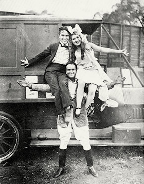 Douglas Fairbanks holding Charlie Chaplin and Mary Pickford on his shoulders in Hollywood. During the epidemic, each star had two films in release. In many cities, moviegoers had to wait until closure orders were lifted in order to see Fairbanks, Chaplin, and Pickford on the silver screen.