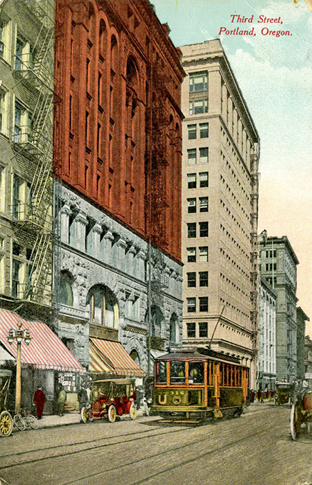 A streetcar runs up Third Street in downtown Portland.