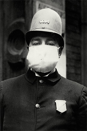 A New York City police officer wears a flu mask while on duty, October 7, 1918.