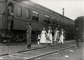 Men on troop train, with Red Cross workers in front. Scenes like this were common throughout the war period and during the epidemic.